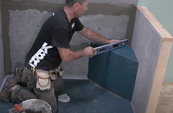 guy installing KBRS Shower Pan