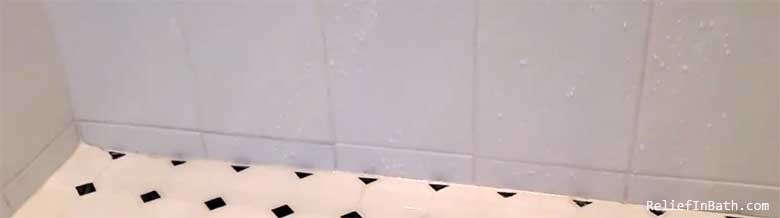water pooling in corner of shower