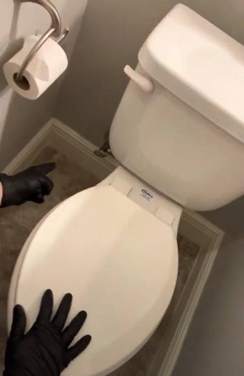 guy fixing skirted toilet issue