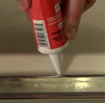 caulking shower doors with weep holes